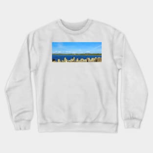 People fishing with a line on an old stone pier on a clear day Crewneck Sweatshirt